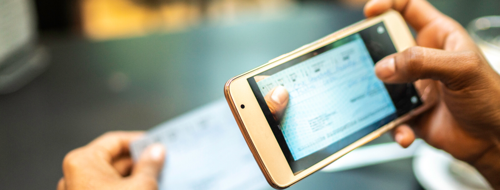 Person using mobile phone to deposit a check