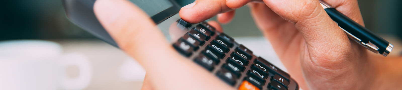 Hands using a calculator